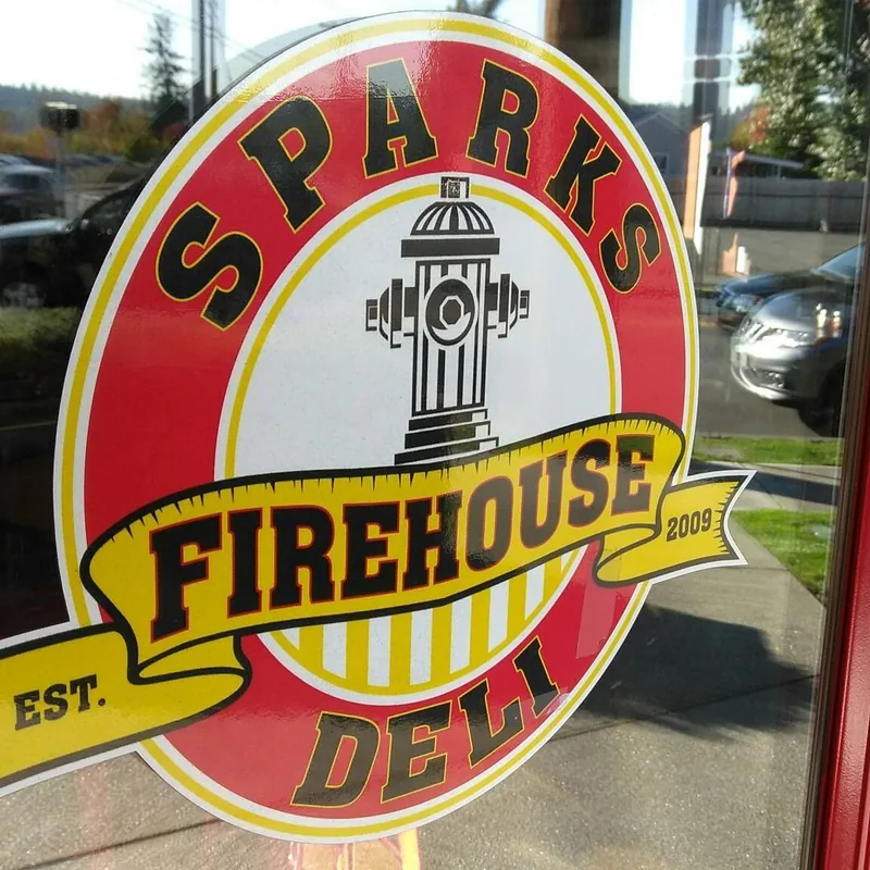 Sparks Firehouse Deli logo on a storefront window.